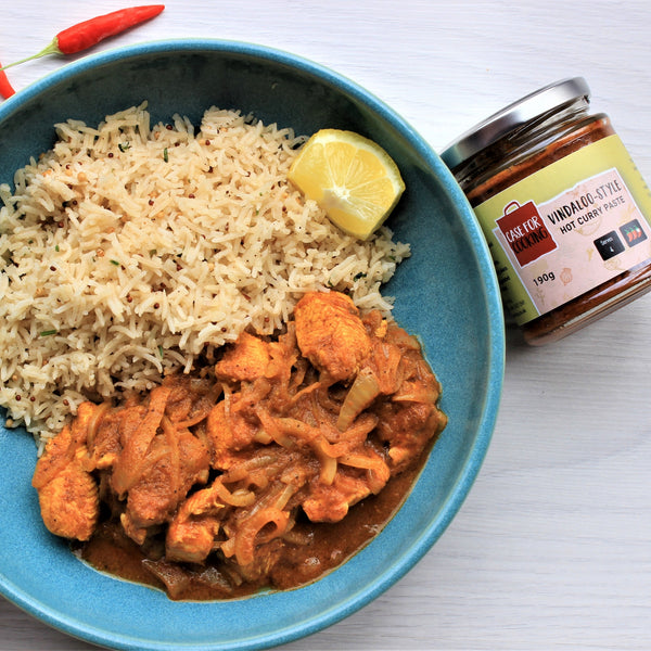 A picture of chicken vindaloo on a plate with rice made from curry paste sold by The Cooking Plumber.