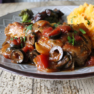 Pan-fried country pork meal with mustard mash on a plate.